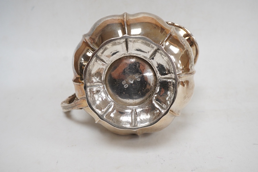 A George IV silver cream jug, with engraved monogram, by William, Charles and Henry Eley, London, 1824, height 10.5cm, 7.7oz.